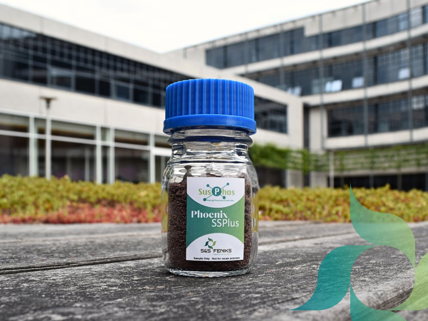 A sample jar of Phoenix SSPlus, a granular phosphate fertilizer.